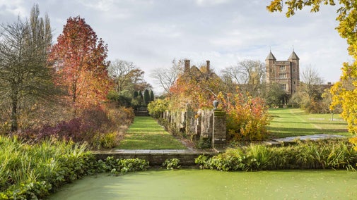 The autumnal colour in the garden at Sissinghurst Castle Garden with the Elizabethan Tower in the distance beyond.